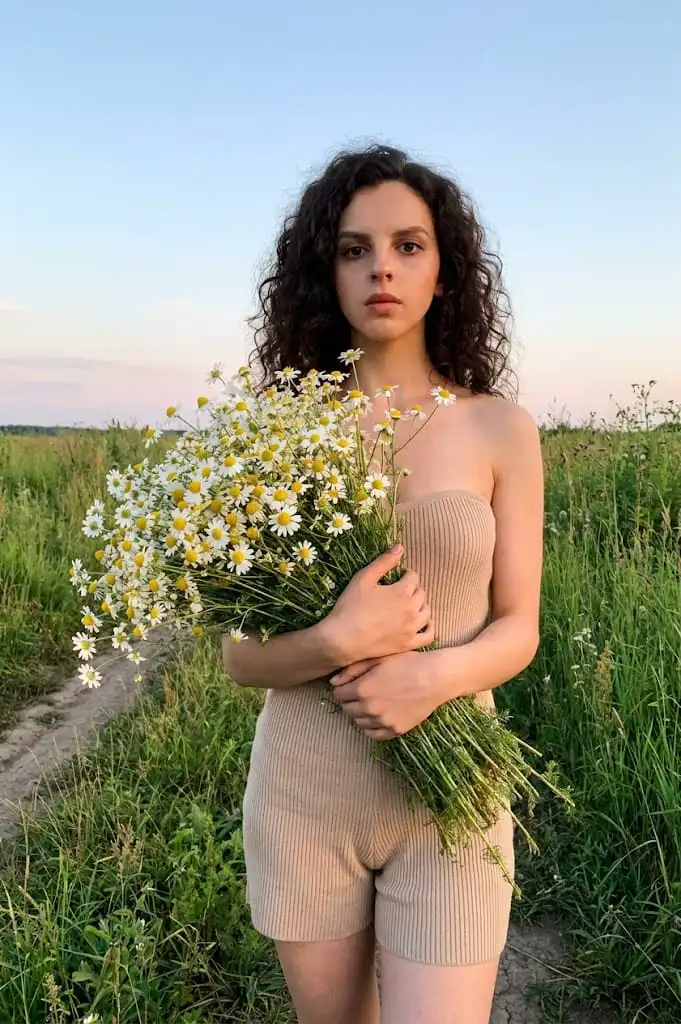Девушка с ромашками на закате